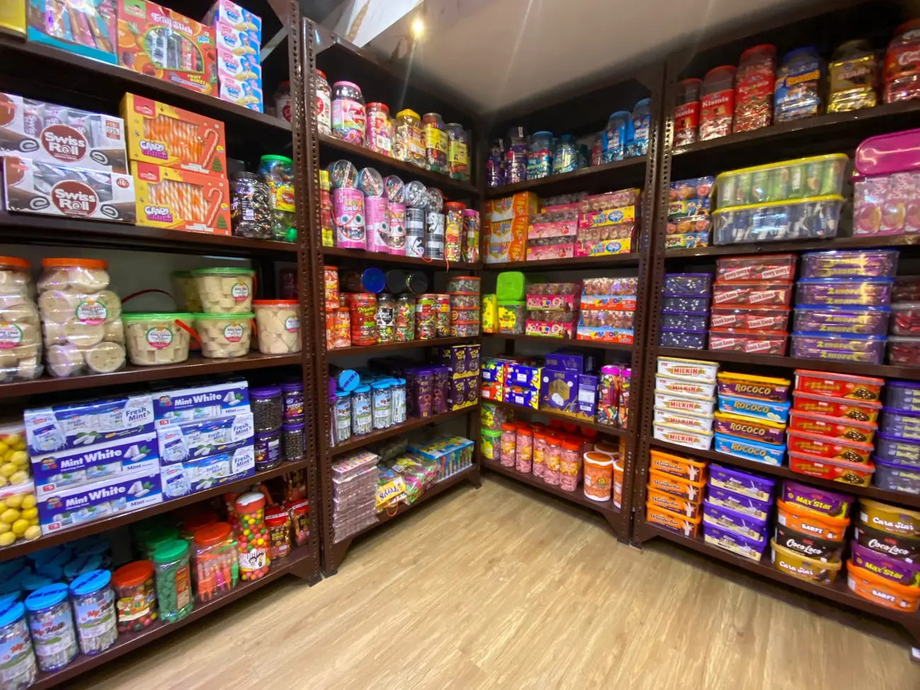 Warehouse shelves stocked with chocolates, candies and jellies at Jeet Trading Company